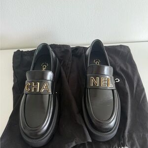 CHANEL Black Leather Slip-On Loafers with Gold Accents